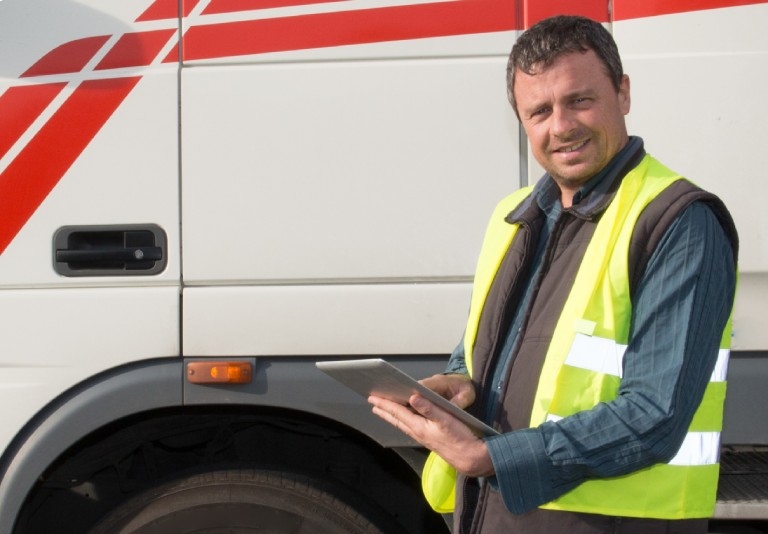 a man standing beside a white truck