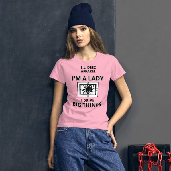 a woman in I DRIVE BIG THINGS pink t shirt