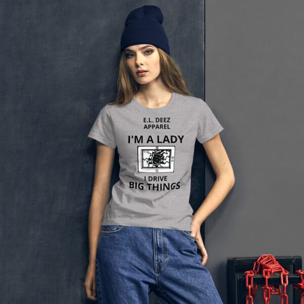 a woman in I DRIVE BIG THINGS grey t shirt